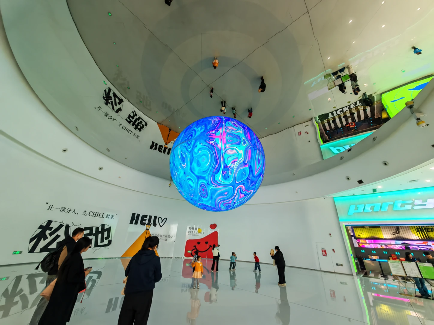 Suspended LED sphere display above a shopping mall atrium floor